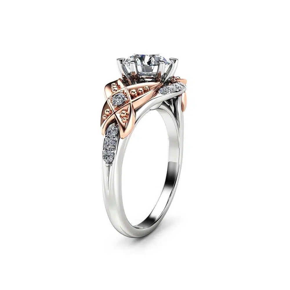 Angled View Art Deco Two-Tone Lab Diamond Ring An angled view of a two-tone Art Deco engagement ring with a round lab diamond and rose gold accents.