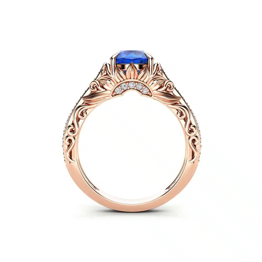 AL-0055C — Rose Gold, profile view of gallery basket Straight-on profile of the rose gold sapphire ring, showing the scalloped filigree gallery basket supporting the stone