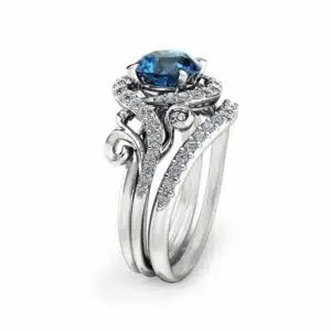 An angled side view of a swirl blue diamond bridal set featuring a halo setting and pavé-set bypass bands.