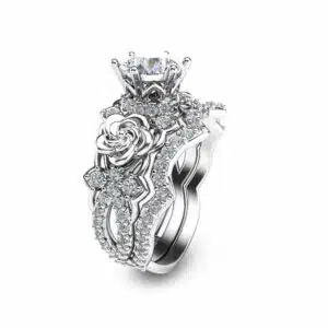 An angled view of a rose-themed bridal set featuring a 1-carat lab diamond and sculpted gold flowers.