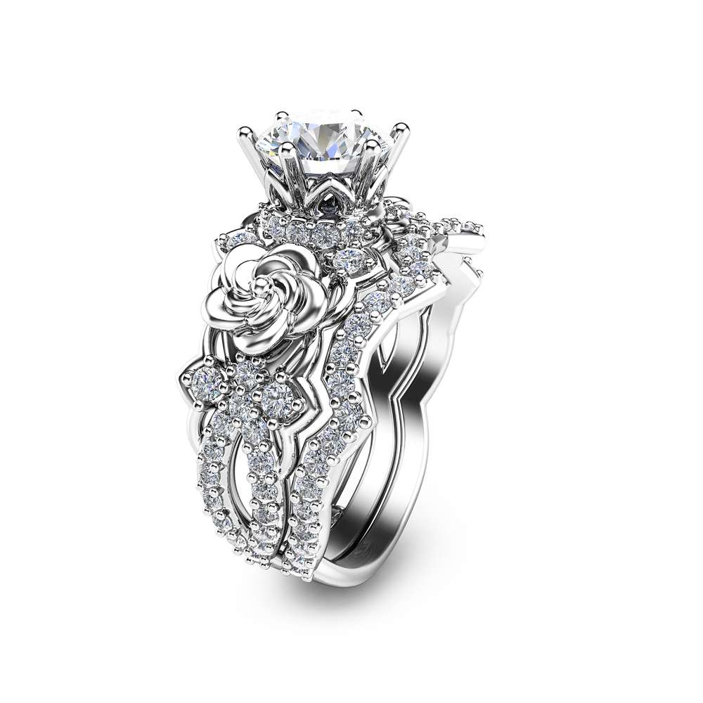 An angled view of a rose-themed bridal set featuring a 1-carat lab diamond and sculpted gold flowers.