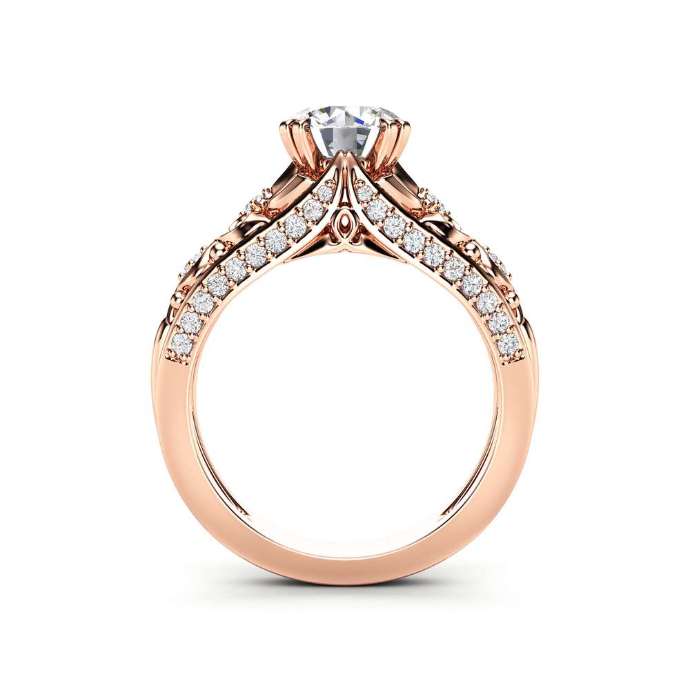 Side profile of the rose gold ring, ornate openwork gallery supporting the moissanite head