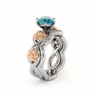 Frontal view of a blossoming blue diamond bridal set with sculpted flowers and clear diamond accents.