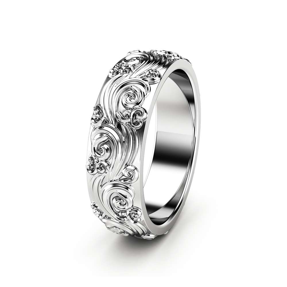 RM-0025A — White Gold, three-quarter view Three-quarter view of the white gold men's band, sculpted volutes and curls raised across the surface
