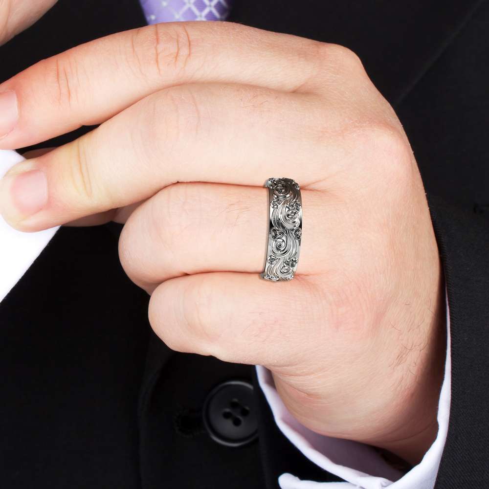 RM-0025A — White Gold, worn on hand Man in a dark suit wearing the white gold hand-carved scrollwork wedding band