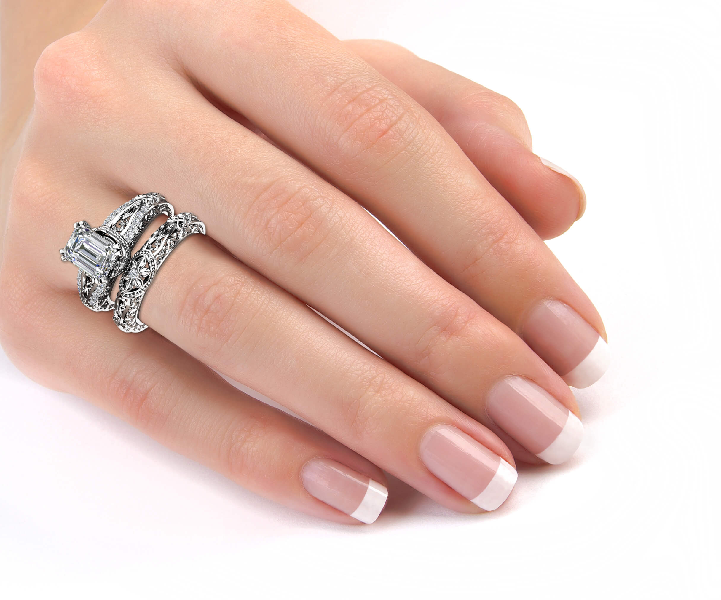 Majestic Emerald Art Deco Bridal Set on Hand A woman's hand wearing the unique Majestic Emerald Art Deco white gold bridal set.