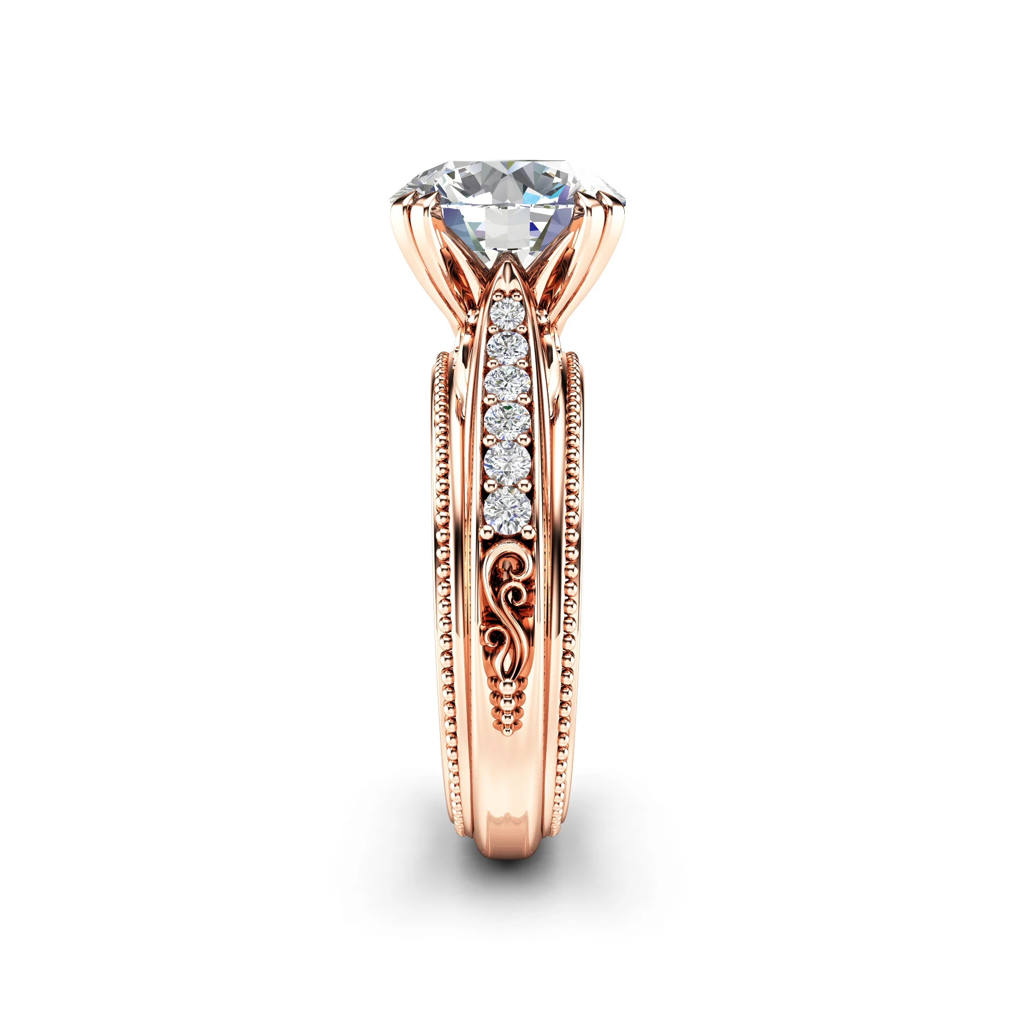 Side angle on a rose gold engagement ring, showing the engraved scrollwork panel on the shank