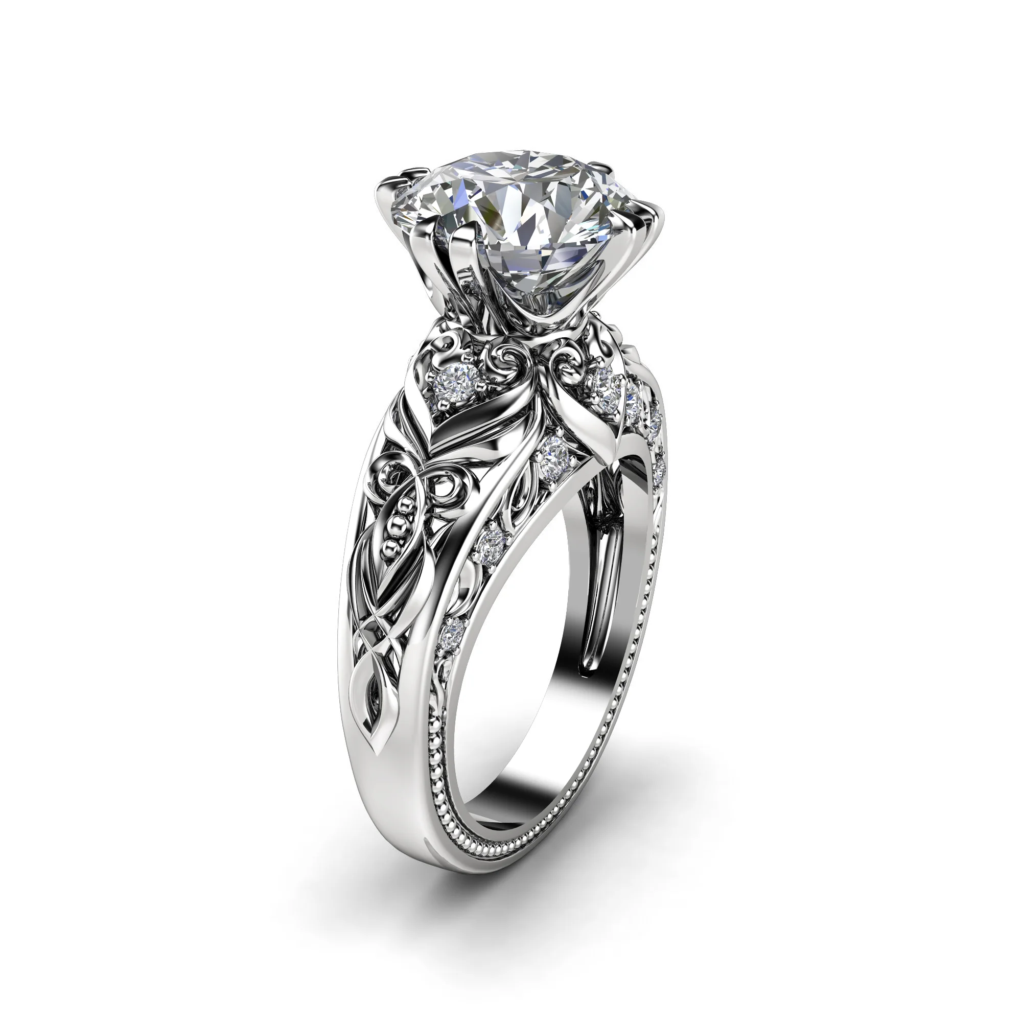 1786996810126-sk8mg6.webp Three-quarter view of a white gold round diamond engagement ring with filigree scrollwork and milgrain